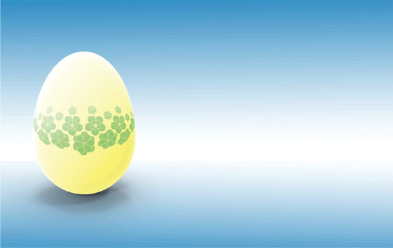 bright yellow eater egg with pale green flowers design over a light blue gradient background