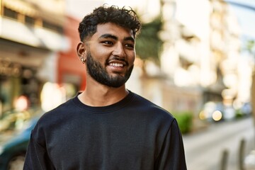Young arab man smiling confident at street