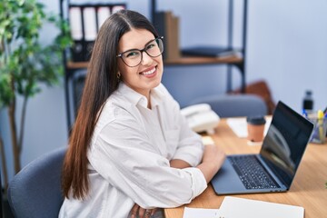 Young hispanic woman business worker using laptop working at office