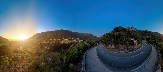 Aerial drone view of the Piana Badlands of Corsica on the D81 route at night. Les Calanques of Piana natural park in Mediterranean sea by the Porto Ota town. 360 degrees panorama of a UNESCO heritage
