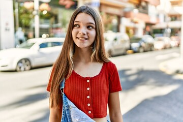 Caucasian teenager girl smiling happy standing at the city.