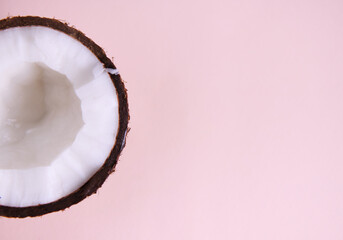 Halved of sweet tasty raw vegan coconut isolated on pink with advertising copy space. Healthy eating. Food background. Still life. Flat lay