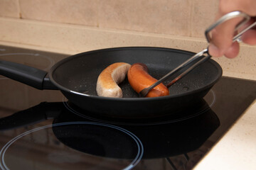 Grilled bratwurst and bockwurst in a pan. Two German sausages. German food concept.