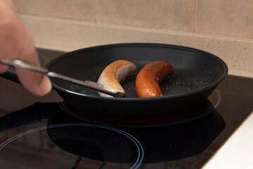 Grilled bratwurst and bockwurst in a pan. Two German sausages. German food concept.