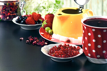 Hibiscus tea and berries on a dark table, space for text, horizontal