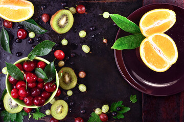ripe cherry fruit and berries in a bowl of pistachio on dark rust metal background, space for text, horizontal