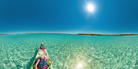 Drone view of people kayaking in the Mediterranean sea by Piana island. Aerial view kayak in the reef of the beach of Piana island, close to the Bonifacio town in Corsica of France.