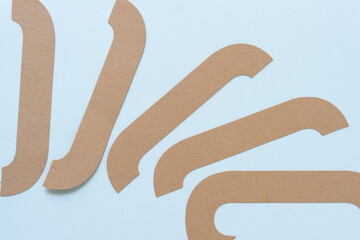 brown paper shapes on a light blue background