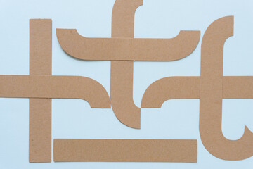 brown paper shapes on a light blue background