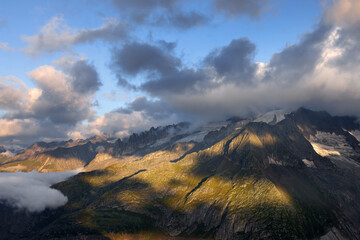 Naklejka na ściany i meble Summer cloudy landscape of the Berner Oberland Alps in Switzerland, Europe