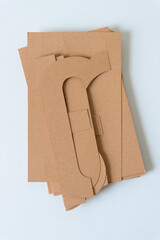 pile of brown paper shapes on blank paper