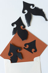 torn paper ornamental shapes with brown paper and envelope