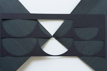 black paper triangles and stencil with semi-circle motif