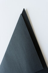 black construction paper folded into a triangle and isolated on white background