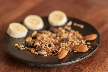Fototapeta na wymiar Banana, oats, raisins and almonds. Preparation. Vegan. Healthy.