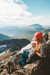 Family hiking in Norway mother and baby traveling in mountains healthy lifestyle mom with infant...