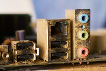 Old motherboard covered in dust and dirt. Close-up.