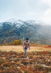 Man hiking in mountains of Norway autumn season active healthy lifestyle adventure vacations trekking in Jotunheimen park eco tourism