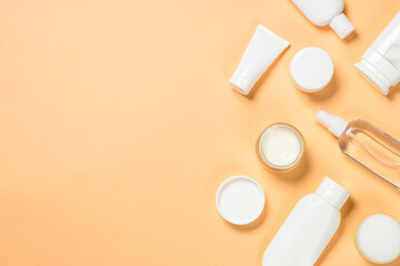 Natural cosmetic products. Cream, mask, tonic and lotion for skin care. Flat lay image at color background.