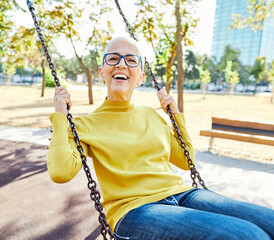 woman outdoor senior healthy exercise fit beautiful happy swing swinging fun leisure retirement elderly active vitality - obrazy, fototapety, plakaty