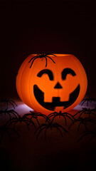 Halloween pumpkin on black background with spiders. Copy Space.
