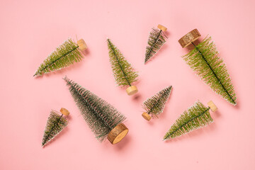 Christmas fir tree at pink background. Flat lay image.