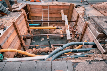 Excavation on a city street to replace plastic water pipes or laying cables. Repair and renovation...