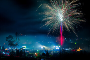 fireworks over the city lights background while event Dieng Culture Festival 2022