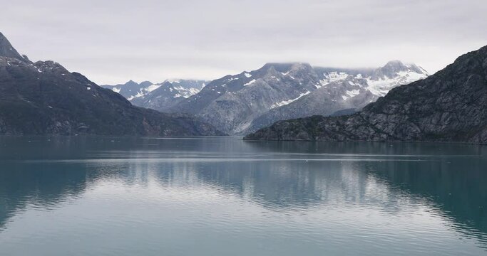 Glacier Bay ocean and mountains. Glacier Bay National Park and Preserve is an American national park. Alaska near Canada. Protected tourism destination accessible boat by sea.