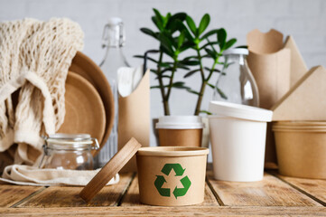 Eco-friendly paper container with a recycling sign. The concept of using biodegradable materials to save the environment.