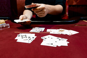 view of the hands of a man playing poker in a casino