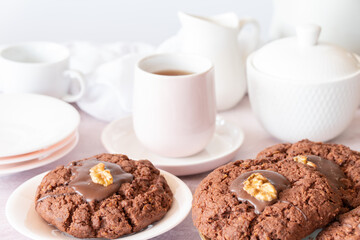 Close Up of Plate of New Zealand Chocolate Afghan Cookies with Cup of Tea, milk jug and sugar