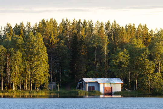 A Small Boathouse On The Bank Of A Lake In Summery Finland