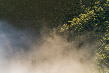 Overhead aerial view of a mountain with fog on its slope, mountain sports concept