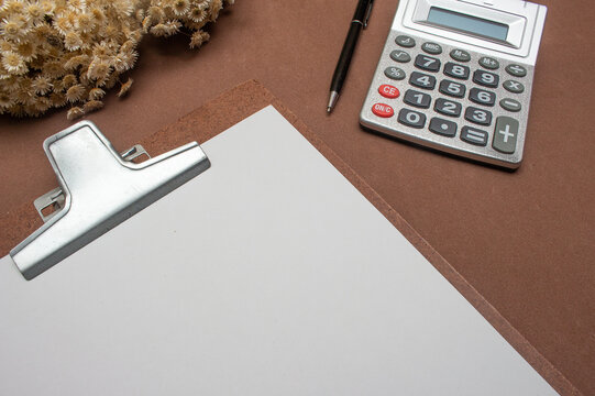 Clipboard And Laptop On Brown Table - Office