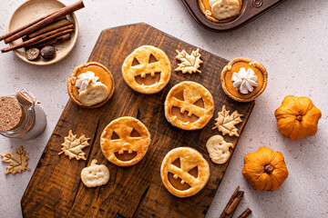 Halloween pumpkin pies with carved pumpkin face on top © fahrwasser