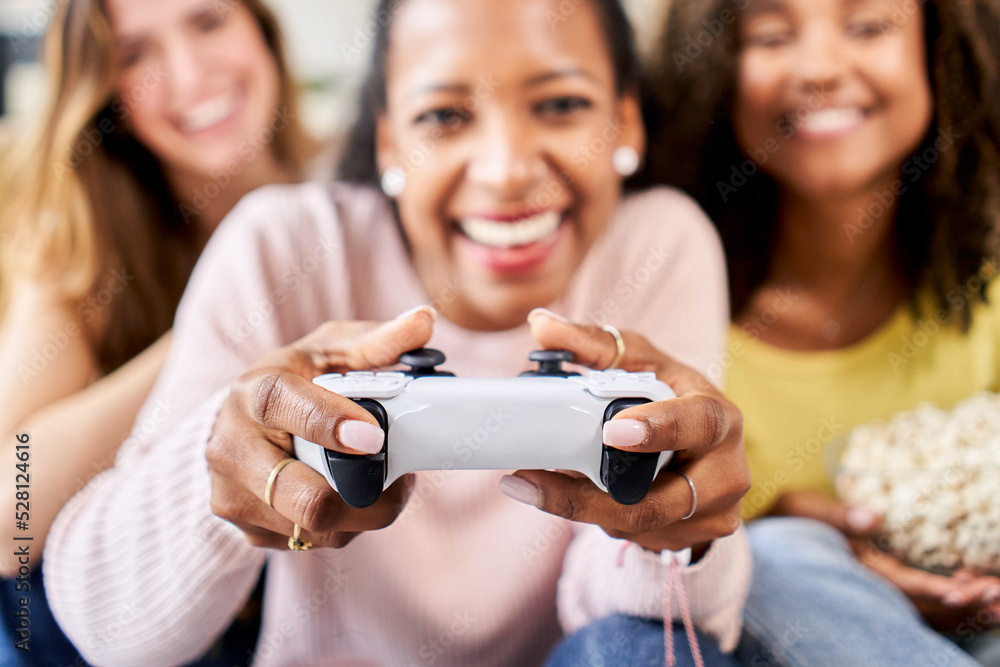 Wall mural close up group of young friends play video games together at home. only women gamers celebrating and