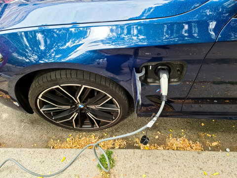 Hamburg, Germany - 03 September 2022: A Blue BMW Electric Car At An Electric Charging Station Seen From Above..