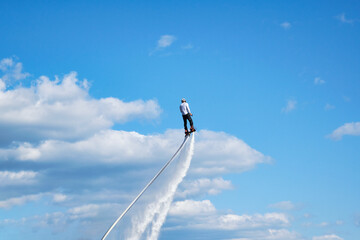 Athlete flies on a FlyBoard against the background of the sky. Extreme sport.