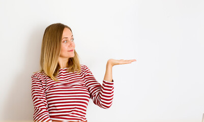 cheerful woman  promoter point index finger suggest select adverts promo over white background