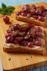 Close up of healthy toast with grapes and cream cheese.