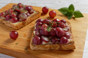 Close up of healthy toast with grapes and cream cheese.