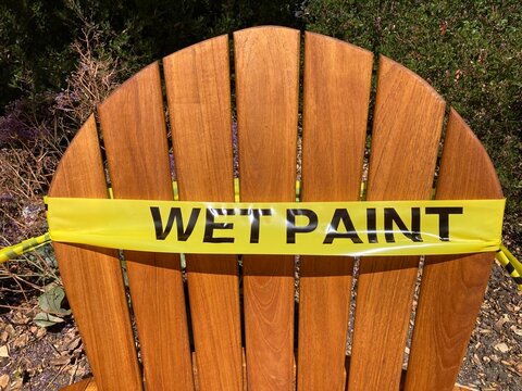 Wet paint sign on a wooden chair