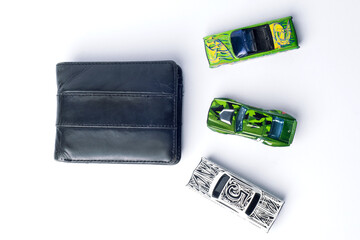 For buying a car. Toy cars and wallets on white background