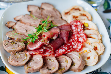meat delicacies on a plate decorated with micro greens. 