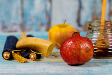 Rosh Hashanah Jewish New Year symbols with shofar glass honey jar the kosher food fresh apples...