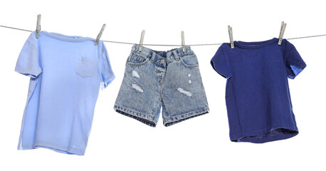 Different clothes drying on washing line against white background