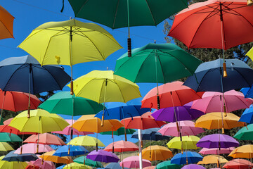 Fototapeta na wymiar Colorful sunlit umbrellas at Lavender Festival, Cherry Valley, CA
