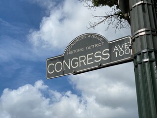 Congress Avenue is a major thoroughfare in Austin, Texas. The street is a six-lane, tree lined avenue that cuts through the middle of the city from far south Austin and goes over Lady Bird Lake leadin - obrazy, fototapety, plakaty