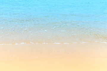 Fototapeta na wymiar Soft blue ocean wave on clean sandy at the beach